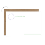 Image of a white flat note card and a kraft brown envelope. The card has the words “with love from” repeating in a circle shape in the top left corner and an example of a name next to it. There is a line in the bottom right corner that extends off of the card.