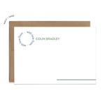 Image of a white flat note card and a kraft brown envelope. The card has the words “with love from” repeating in a circle shape in the top left corner and an example of a name next to it. There is a line in the bottom right corner that extends off of the card.
