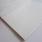 Image of lined paper inside of the letter writing pad